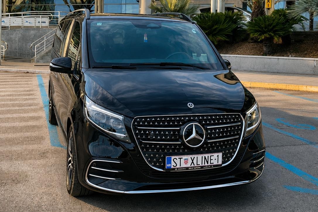 Black Mercedes-Benz V-Class private transfer vehicle waiting outside Split Airport arrivals in Croatia