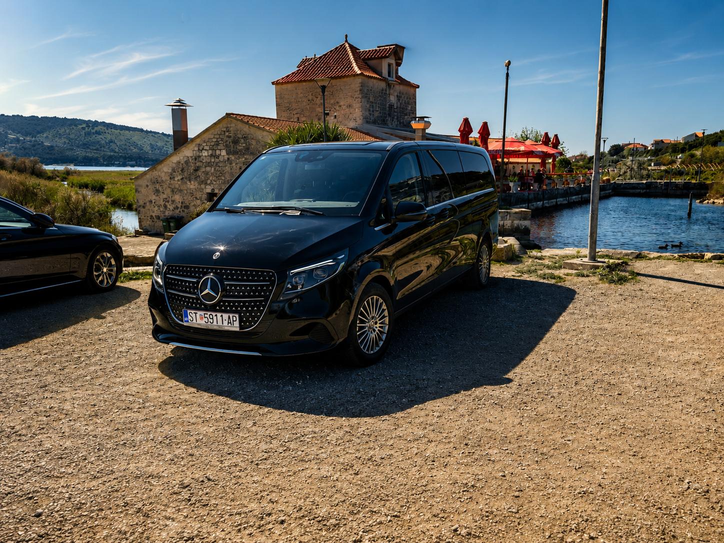 Black Mercedes-Benz V-Class private transfer vehicle parked on the Dalmatian coast near Split