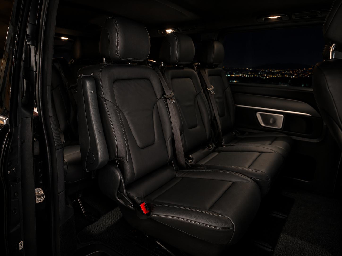 Black leather rear cabin of a Mercedes-Benz V-Class private transfer vehicle at night in Split