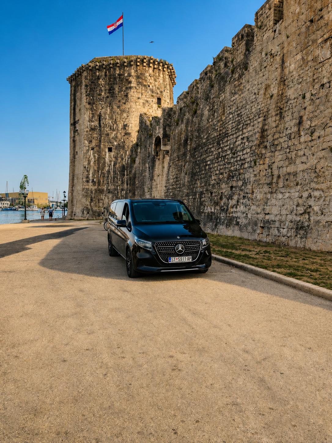 Mercedes-Benz V-Class excursion vehicle beside the walls of Trogir old town near Split