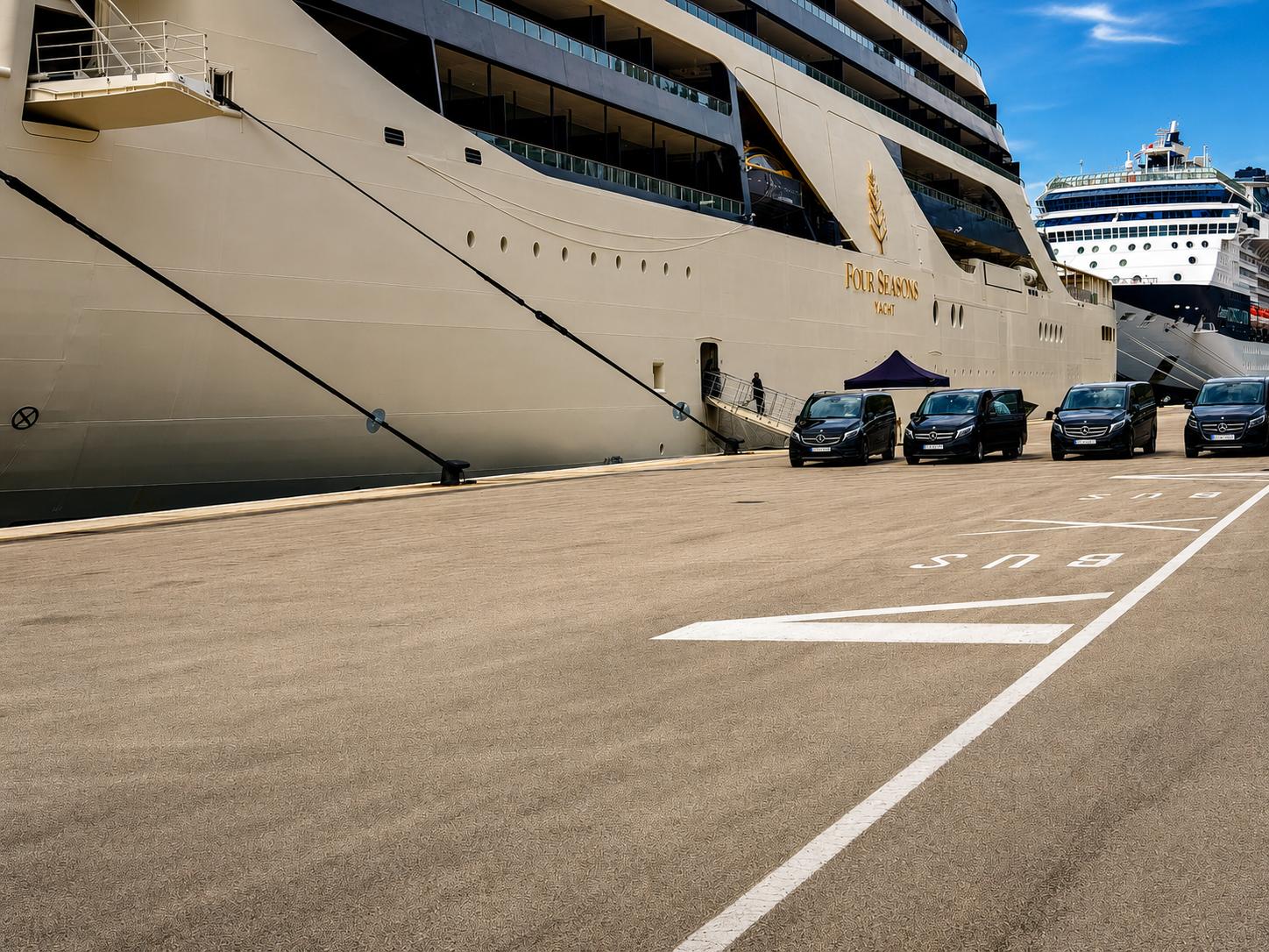 Fleet of black Mercedes-Benz vans lined up for cruise guest transfers at the port of Split